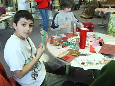Isaac Abouaf and Hunter Carol work on Valentine cards at Art and Cloth.