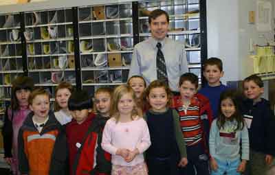 Acting Postmaster Paul Rice poses with children from the Village Nursery School who took a field trip to the post office on Tuesday to mail their valentines. (Courtesy photo)