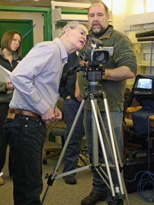 Cable Committee member Jonathan Williams provides instruction to Nick Kouros, a student in the Cable Committee’s producer course, while fellow student Shara Drew looks on during a recent session of the program. (Photo by Lisa Aciukewicz)