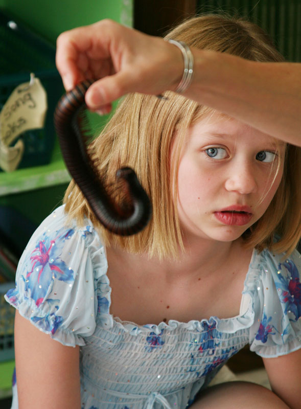 Abigail Pacl reacts to a giant African millipede.