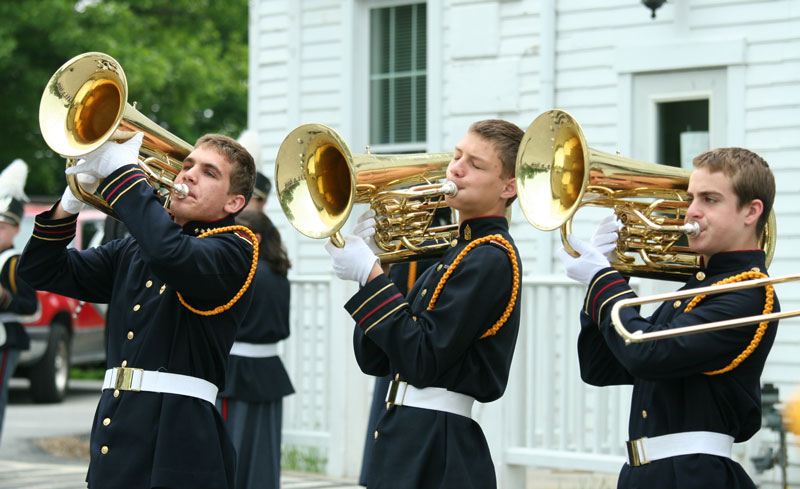 Anthony Fill, Ian Vicherek, and Gregory McNeal of the Immaculate Heart of Mary School in Still River warm up in front of Town Hall before the parade.