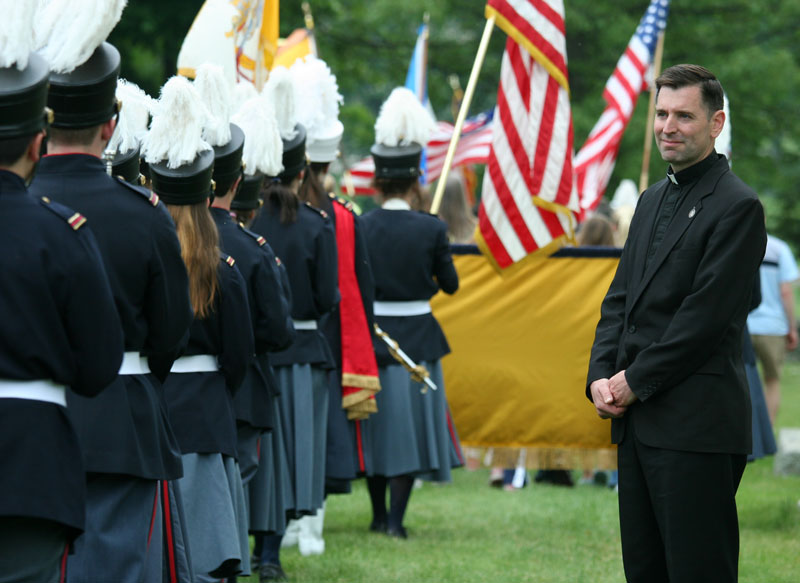 Band director Brother Peter Mary watches as the Immaculate Heart of Mary School Band marches by.