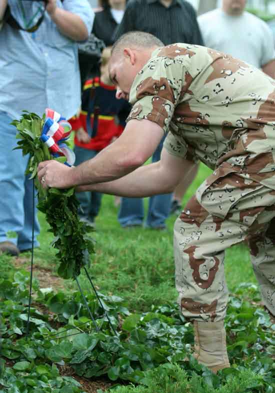 Oleh Dutkewych, a Desert Storm veteran, places a wreath on the Common