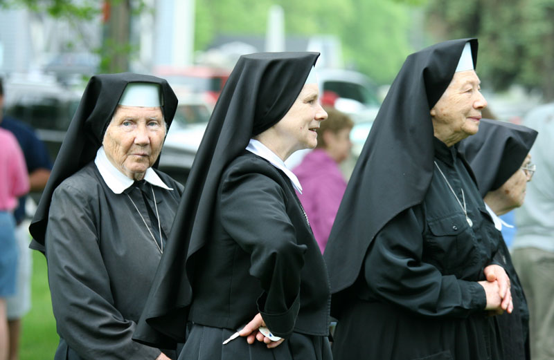 Sisters Monica, Mary Lawrence, and Cecilia of St. Anne’s House listen to the Memorial Day music on the Common.